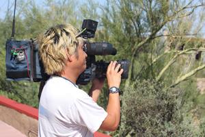 A filmmaker shooting footage from the entrance patio